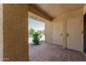 Private patio features brick flooring and outdoor storage closets at 8301 N 21St Dr # F102, Phoenix, AZ 85021