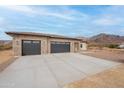 Beautiful home with a spacious three car garage, desert landscaping and mountain views at 9626 E Bunny Ear E Ln, Gold Canyon, AZ 85118