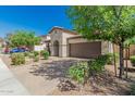 Charming single-Gathering home with a two-car garage and desert landscaping at 9747 W Sands Dr, Peoria, AZ 85383