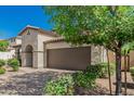 Charming single-Gathering home with a two-car garage and desert landscaping at 9747 W Sands Dr, Peoria, AZ 85383