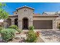 Beautiful single-Gathering home featuring desert landscaping and an arched entryway at 9747 W Sands Dr, Peoria, AZ 85383