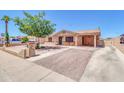 Charming single story home featuring a brick paved driveway, covered parking, and a cozy front porch seating area at 1018 S Toltec --, Mesa, AZ 85204