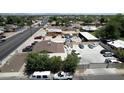 Aerial view of buildings, parking, and surrounding houses and street at 1039 E Broadway Rd, Mesa, AZ 85204