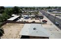 Property aerial view showcasing the lot, street, and nearby homes at 1039 E Broadway Rd, Mesa, AZ 85204
