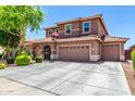 Expansive home with a wide driveway, three-car garage, and a well-maintained lawn creates a striking curb appeal at 13123 W Cottontail Ln, Peoria, AZ 85383