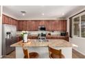 Modern kitchen boasts granite countertops, stainless steel appliances, and ample cabinet space, perfect for cooking and entertaining at 13123 W Cottontail Ln, Peoria, AZ 85383