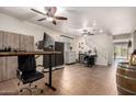 Well-lit home office featuring multiple work areas, including built-in storage and plenty of room for creative projects at 13123 W Cottontail Ln, Peoria, AZ 85383