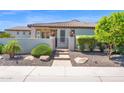 Inviting property entrance with desert landscaping and stylish fence at 1462 E Sweet Citrus Dr, Queen Creek, AZ 85140