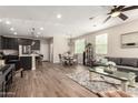 Open-concept living space with wood-look tile, modern lighting, and neutral decor at 1849 E Chelsea Ln # 107, Gilbert, AZ 85295