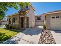 Beautiful home with a stone-clad entrance, spacious driveway, and well-maintained lawn at 1851 E Ellis St, Phoenix, AZ 85042