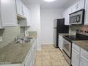 Efficient kitchen features stainless appliances, granite countertops, and white cabinets at 200 E Southern Ave # 363, Tempe, AZ 85282