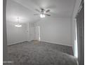 Bright, carpeted living room featuring neutral colors, modern lighting, and ample natural light at 200 E Southern Ave # 363, Tempe, AZ 85282