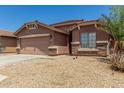 Attractive single-level home with a two-car garage and desert-friendly landscaping at 2025 S 83Rd Dr, Tolleson, AZ 85353