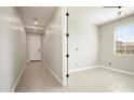 Bright, empty bedroom featuring neutral tile floors, a window, and a hall closet at 20644 W Mariposa St, Buckeye, AZ 85396