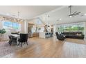 Bright open-concept living space featuring sleek flooring, a modern kitchen island with bar seating, and a comfortable lounge area at 21391 W Mariposa St, Buckeye, AZ 85396