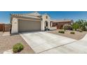 Charming home featuring a concrete driveway, desert landscaping, and a well-maintained front yard at 25915 W Tina Ln, Buckeye, AZ 85396