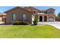Charming two-story home featuring a well-maintained lawn and appealing desert landscaping at 3065 E Harvard Ave, Gilbert, AZ 85234
