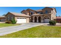 Attractive stucco home boasting multiple garages and a spacious driveway at 3065 E Harvard Ave, Gilbert, AZ 85234