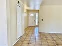 Inviting foyer with neutral walls, tiled flooring, closet storage, and views of the front door at 3121 W Laurie Ln, Phoenix, AZ 85051