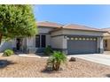 Charming single-story home featuring a gray two-car garage and a well-maintained desert landscape at 3668 E Derringer Way, Gilbert, AZ 85297