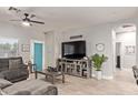 Comfortable living room with a large gray sectional couch and a modern entertainment center at 3668 E Derringer Way, Gilbert, AZ 85297