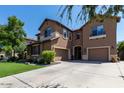 Attractive home featuring a three-car garage, stone accents and a well-manicured front lawn at 3693 E Sparrow Pl, Chandler, AZ 85286