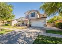 Attractive two-story home with a well-kept lawn, brick-accented porch, and an attached two-car garage at 3931 E Weather Vane Rd, Gilbert, AZ 85296