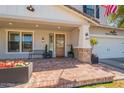Close-up of the brick-paved front porch, showcasing the stylish entrance and decorative flower planters at 3931 E Weather Vane Rd, Gilbert, AZ 85296