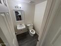 Efficient bathroom with contemporary fixtures, including sink and toilet at 4111 W Reade Ave, Phoenix, AZ 85019