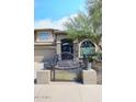 Charming two-story home features a tile roof, arched entryway, three-car garage and gated courtyard at 4530 E White Feather Ln, Cave Creek, AZ 85331