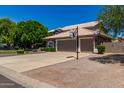 Spacious home featuring a three-car garage, basketball hoop, and well-maintained landscaping at 4648 W Misty Willow Ln, Glendale, AZ 85310