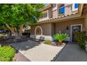 Charming front porch with mature plants, a bench, and a decorative wall hanging at 4648 W Misty Willow Ln, Glendale, AZ 85310