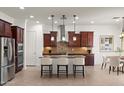 Modern kitchen with stainless steel appliances, dark wood cabinets, and a center island with seating at 5650 E Ocupado Dr, Cave Creek, AZ 85331