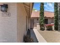 Inviting front entrance with a tile roof, well-manicured landscaping, and a stucco exterior at 5758 E Fox St, Mesa, AZ 85205