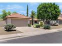 Well-maintained single-Gathering home with desert landscaping, a driveway, and a two-car garage at 5758 E Fox St, Mesa, AZ 85205