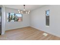 Bright dining room featuring modern chandelier, large window with a view, and light flooring at 7810 E Via Camello -- # 72, Scottsdale, AZ 85258