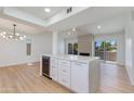 Open-concept kitchen featuring custom island, stainless steel wine fridge, and modern finishes at 7810 E Via Camello -- # 72, Scottsdale, AZ 85258