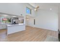 Open living space with kitchen bar, modern light fixture, vaulted ceilings, and bright lighting at 7810 E Via Camello -- # 72, Scottsdale, AZ 85258