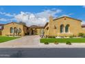 Stucco home with tile roof, beautiful archways, desert landscaping, and a well-maintained front lawn at 8298 E Tailfeather Dr, Scottsdale, AZ 85255