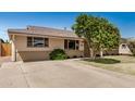 Home with well-kept lawn, mature landscaping, and a long driveway at 844 E Ruth Ave, Phoenix, AZ 85020