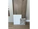 A curated selection of modern interior materials, including granite, woodgrain floors, and paint trim at 8552 N 175Th Ln, Waddell, AZ 85355
