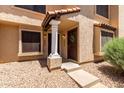 Charming townhome entrance with dual doors, desert landscaping, and pillar-supported entryway at 921 W University Dr # 1232, Mesa, AZ 85201