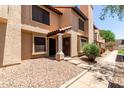 Inviting townhome showcasing desert landscaping and a cozy entryway with a wreath-adorned door at 921 W University Dr # 1232, Mesa, AZ 85201