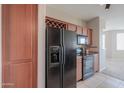 Kitchen with stainless steel appliances, wood cabinets, and wine rack at 9820 N Central Ave # 212, Phoenix, AZ 85020