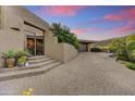 Close-up of home exterior and driveway, featuring a secure gated entrance and desert landscaping at 10638 E Honey Mesquite Dr, Scottsdale, AZ 85262