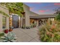 Desert home featuring a courtyard entry with unique architecture and lush vegetation at 10638 E Honey Mesquite Dr, Scottsdale, AZ 85262