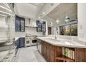 Gourmet kitchen featuring stainless steel appliances, large island, and modern cabinetry at 10638 E Honey Mesquite Dr, Scottsdale, AZ 85262
