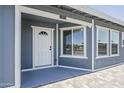 Covered entry featuring a half-light door, sidelight window, and a neatly painted exterior at 11012 E Elton Ave, Mesa, AZ 85208