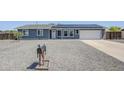 Inviting single-story home with solar panels, gravel landscaping, and a well-kept front lawn at 11012 E Elton Ave, Mesa, AZ 85208