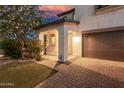 Charming two-story home showcasing a well-kept lawn and paved driveway leading to the attached garage at 11541 E Corbin Ave, Mesa, AZ 85212